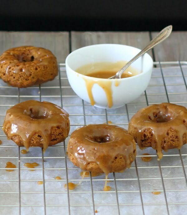 Baked Pumpkin Doughnuts with Salted Maple Caramel Recipe - These soft and fluffy baked pumpkin doughnuts are drizzled with a salted maple caramel for a sticky-sweet breakfast treat!