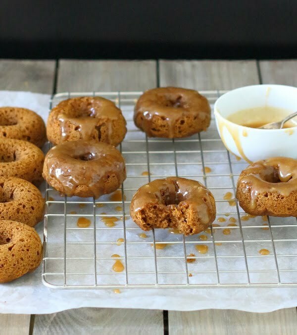 Baked Pumpkin Doughnuts with Salted Maple Caramel Recipe - These soft and fluffy baked pumpkin doughnuts are drizzled with a salted maple caramel for a sticky-sweet breakfast treat!
